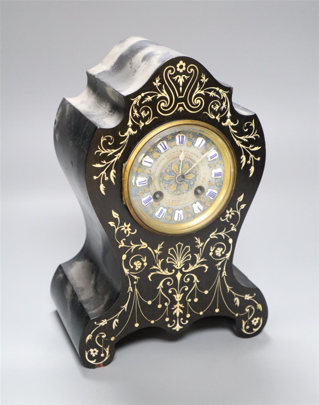 A 19th century French inlaid mantel clock with enamelled numerals, countwheel striking on a bell, 26cm